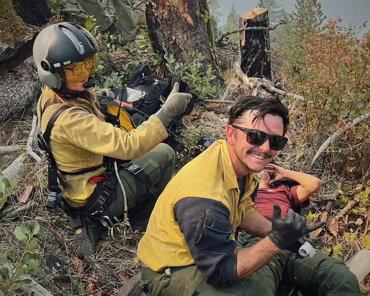 Two firefighters taking a break on the line